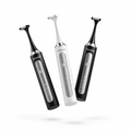 Three Flossei electric flosser handles, two Midnight Black and one Arctic White, tumbling in mid air with no charging dock, monochrome logo